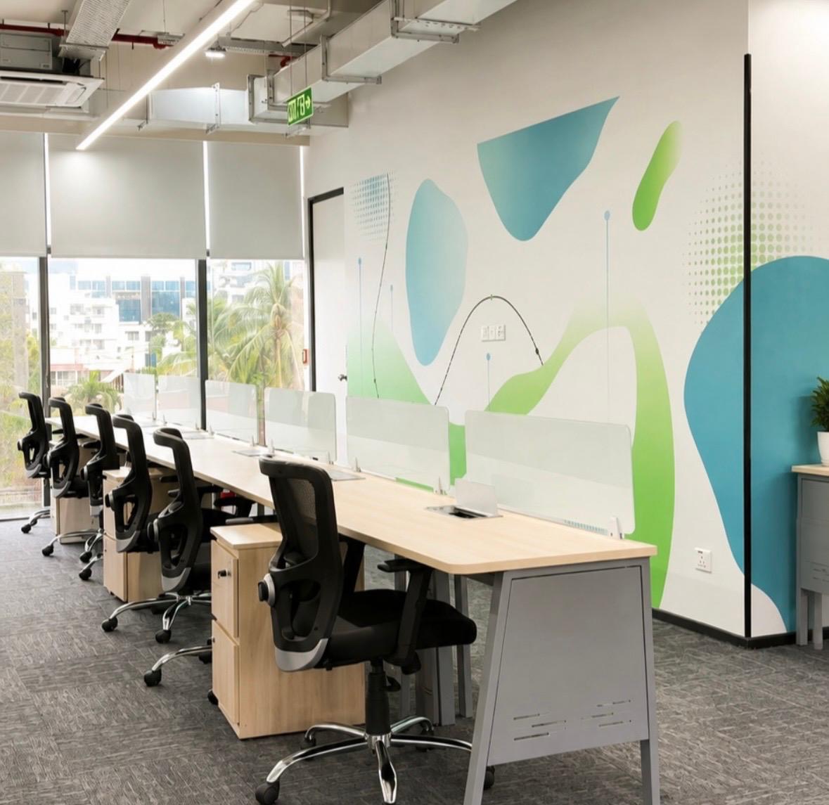 Clean row of office workstations with frosted glass privacy dividers